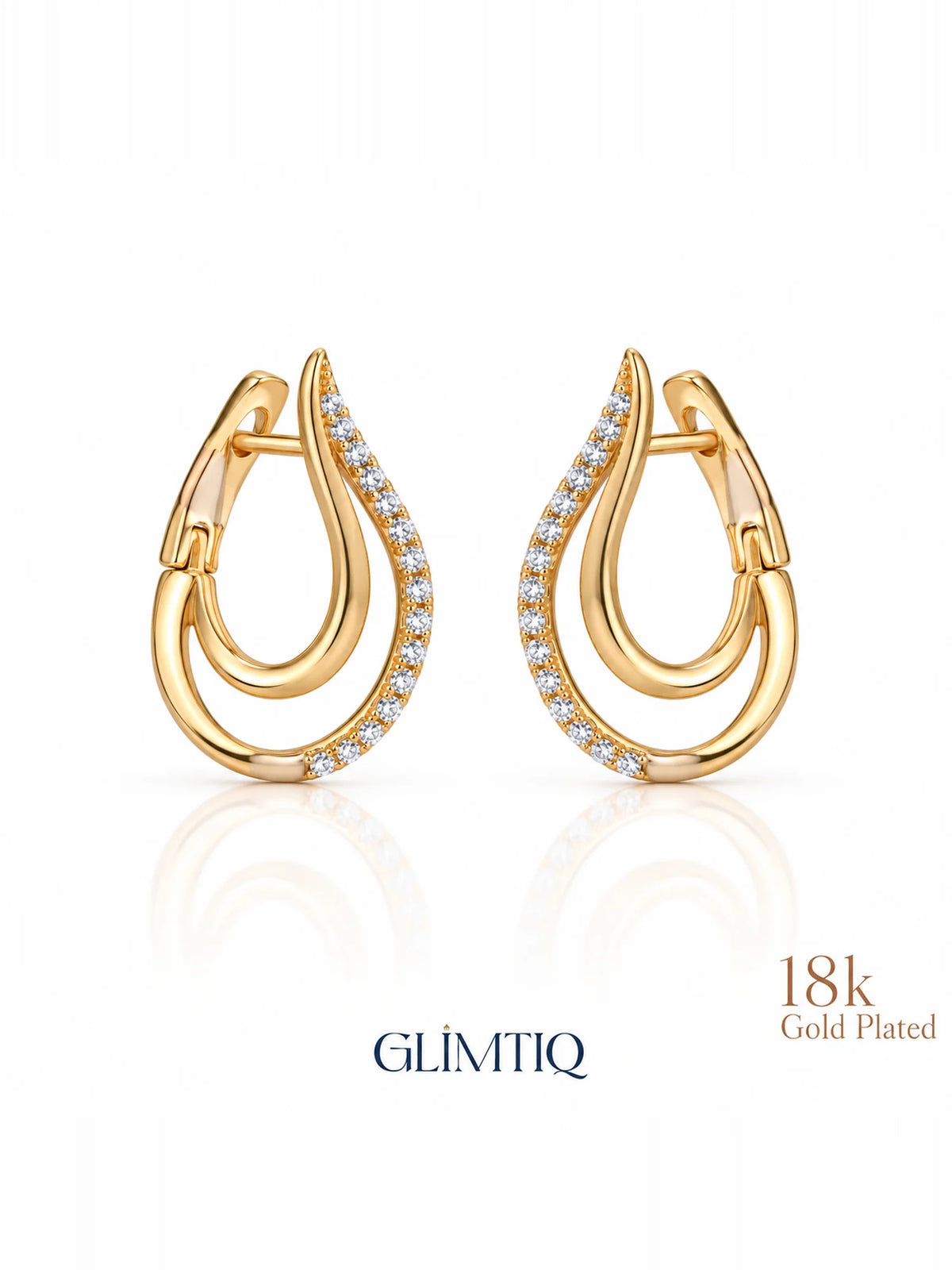 Close view of golden swoop 18k gold plated huggie earrings showing double-curve huggie with clear accents on the outer curve