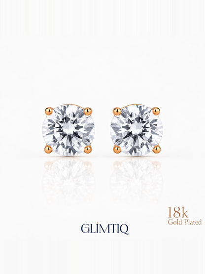Close view of Celeste Round clear-centre stud earrings with warm gold-toned prongs