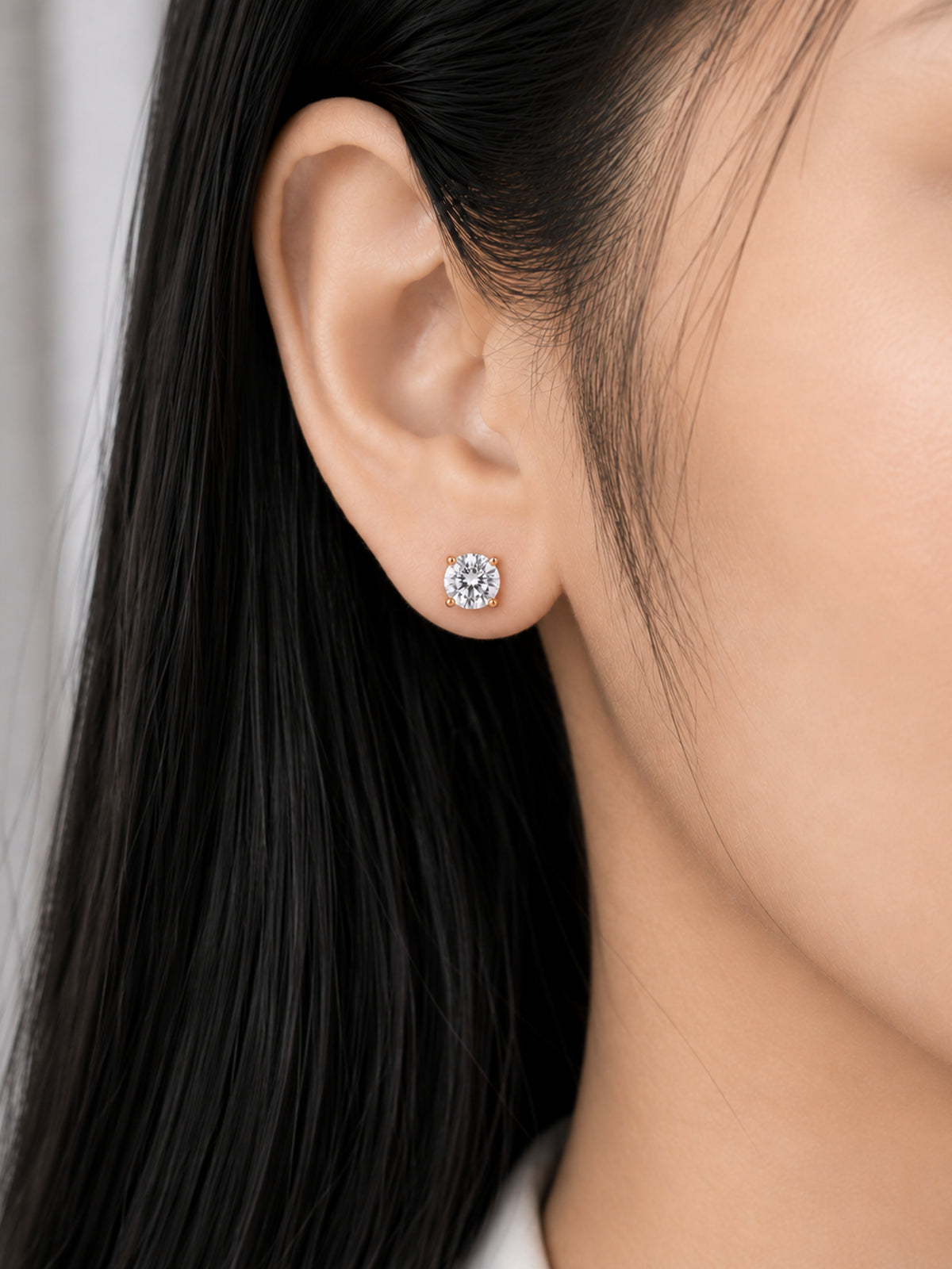 Celeste Round stud earring worn on a model's ear