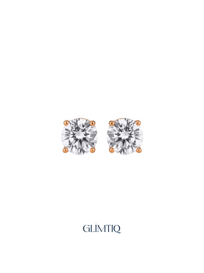 Pair of Celeste Round gold-plated stud earrings with clear round centres in four-prong settings