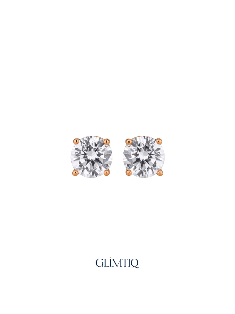 Pair of Celeste Round gold-plated stud earrings with clear round centres in four-prong settings