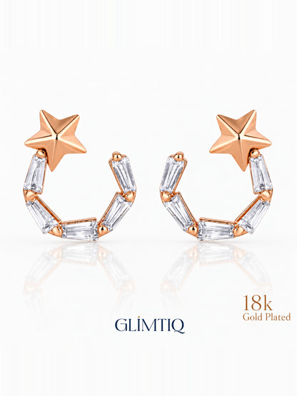 Close view of celestial star 18k rose gold plated drop earrings showing star top with an open curved drop of clear rectangular accents