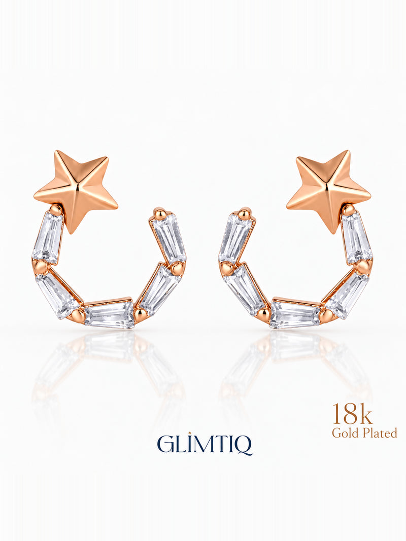 Close view of celestial star 18k rose gold plated drop earrings showing star top with an open curved drop of clear rectangular accents