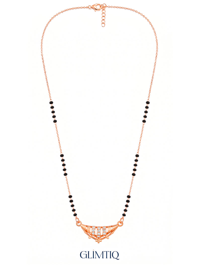 Full rose gold crescent floral mangalsutra showing black bead sections, sparkling pendant, lobster clasp and extension chain.