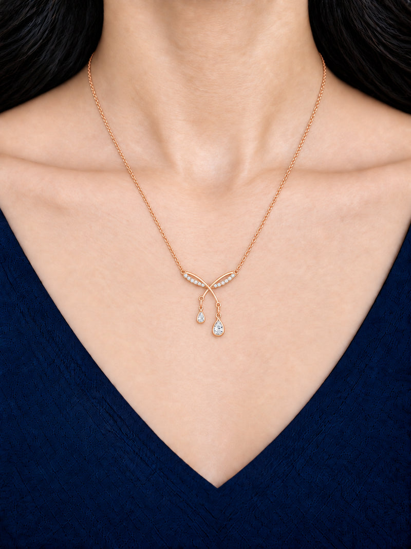 Criss Cross Dangles 18K Gold Plated Necklace worn on a model in a navy outfit