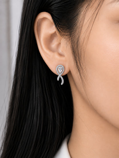 Crossed Ribbon teardrop stud earring worn on a model's ear