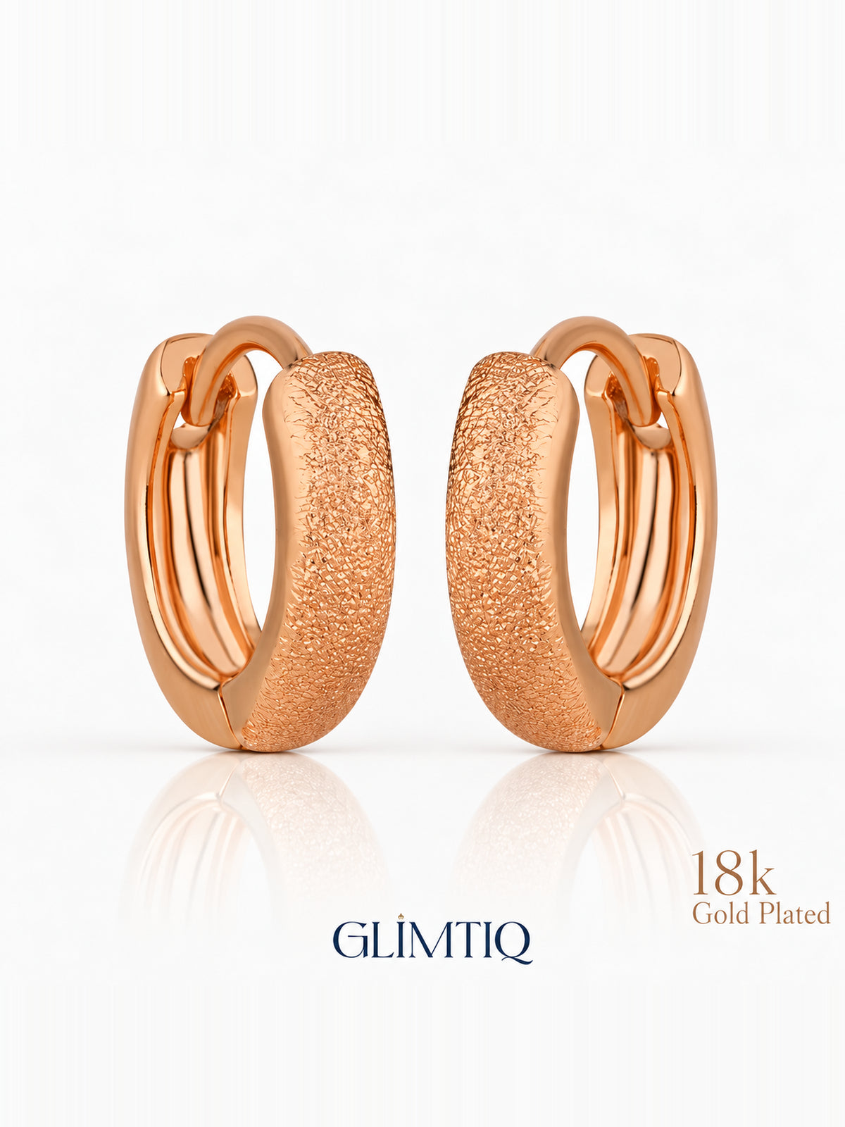 Close view of everyday gleam 18k rose gold plated huggie earrings showing textured, stone-free compact hoop