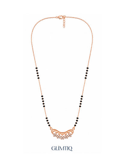 Full rose gold mangalsutra showing black bead sections, curved row of rose-gold hearts above sparkling flower clusters, lobster clasp and extension chain.