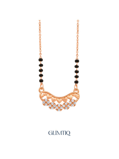 Close-up of rose gold mangalsutra pendant featuring curved row of rose-gold hearts above sparkling flower clusters.