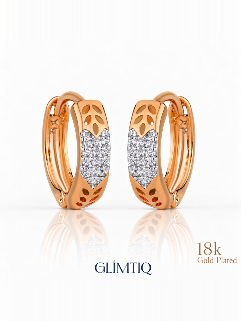 Close view of golden leaf 18k rose gold plated hoops showing leaf cutouts with a sparkling front panel