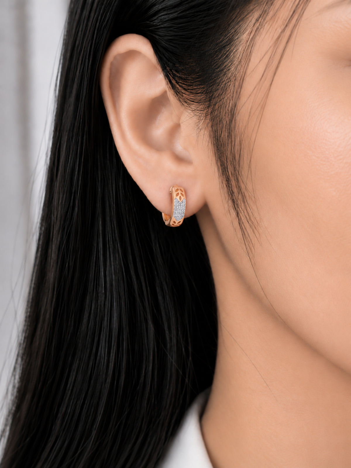 Golden Leaf 18K Rose Gold Plated Hoops worn on a model's ear