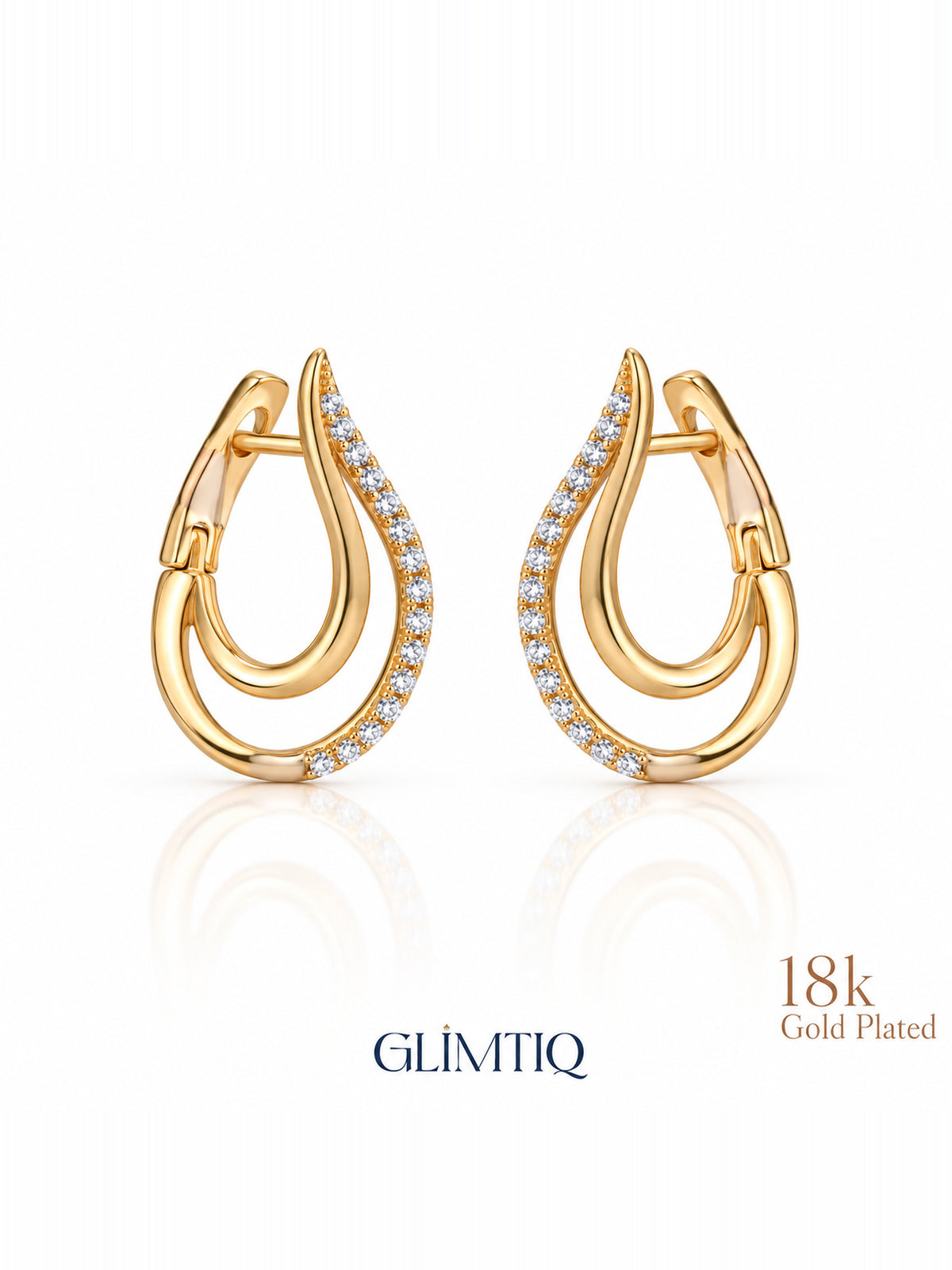 Close view of golden swoop 18k gold plated huggie earrings showing double-curve huggie with clear accents on the outer curve