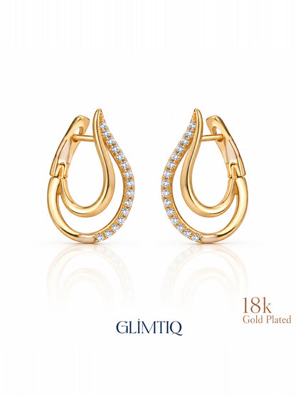 Close view of golden swoop 18k gold plated huggie earrings showing double-curve huggie with clear accents on the outer curve