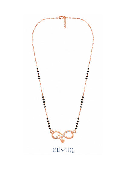Full rose gold mangalsutra showing black bead sections, infinity pendant with sparkling accents and a hanging heart charm, lobster clasp and extension chain.
