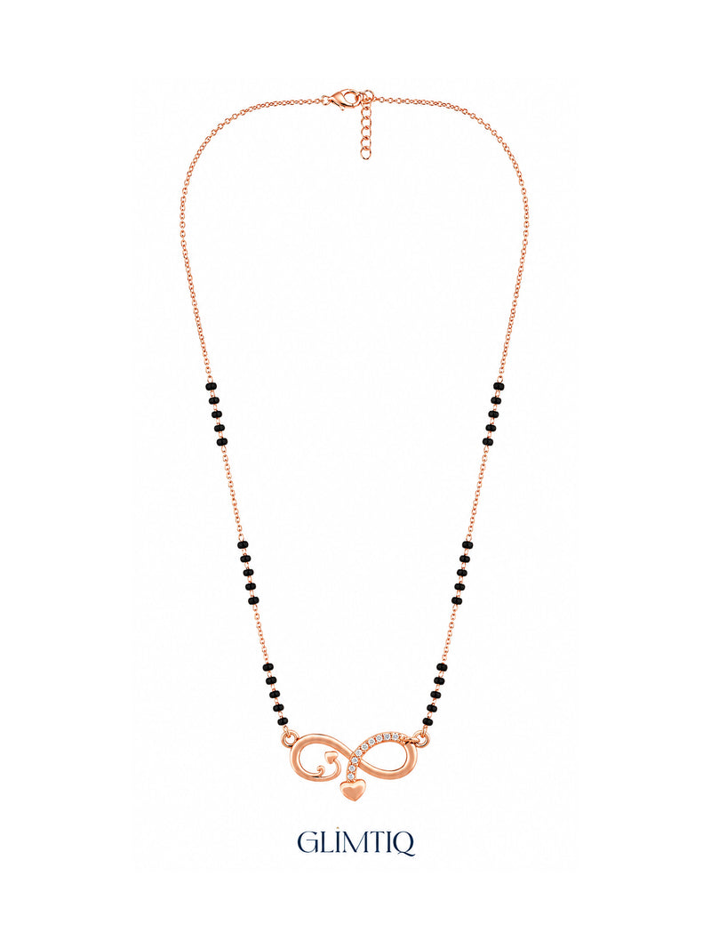Full rose gold mangalsutra showing black bead sections, infinity pendant with sparkling accents and a hanging heart charm, lobster clasp and extension chain.