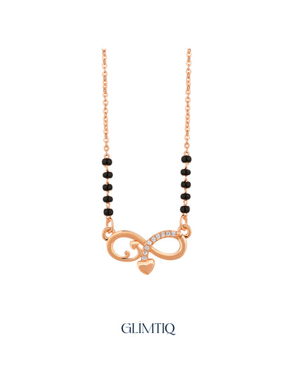 Close-up of rose gold mangalsutra pendant featuring infinity pendant with sparkling accents and a hanging heart charm.