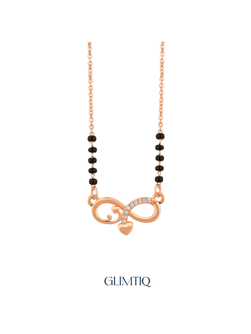 Close-up of rose gold mangalsutra pendant featuring infinity pendant with sparkling accents and a hanging heart charm.