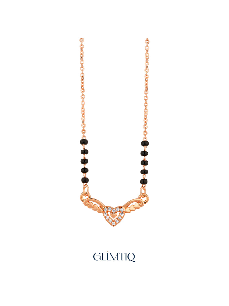 Close-up of rose gold mangalsutra pendant featuring sparkling double-heart pendant with heart-shaped wings.