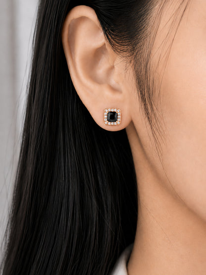 Rose-gold square black-centre stud earring worn on a model's ear