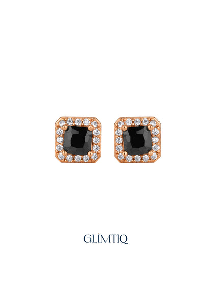 Pair of rose-gold square stud earrings with black centres and clear sparkling borders on white background