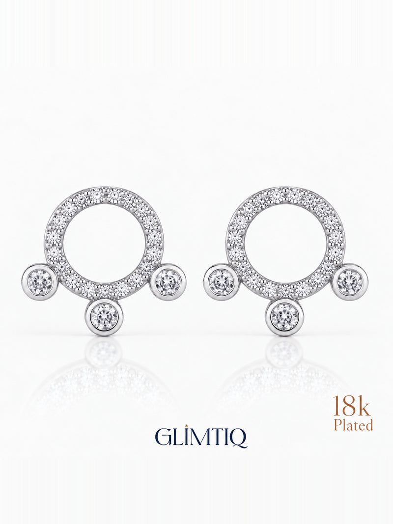 Close view of orbit trio 18k gold plated stud earrings showing sparkling open circle with three round accents