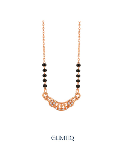Close-up of rose gold mangalsutra pendant featuring crescent pendant with two sparkling flowers and petal details.