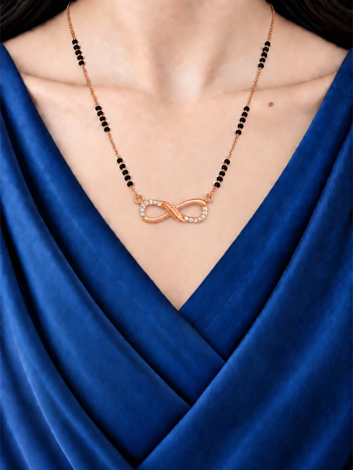 Sparkling Infinity mangalsutra with black beads shown worn on a model.