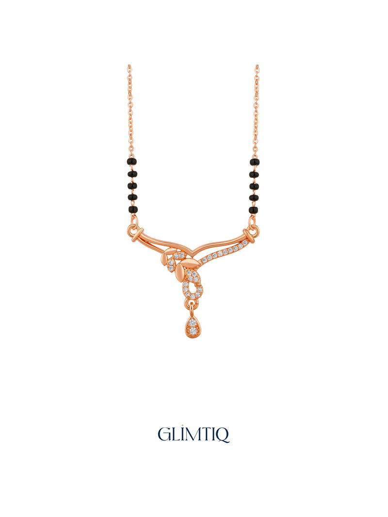 Close-up of rose gold mangalsutra pendant featuring flowing leaf trail with a sparkling open drop and hanging teardrop.
