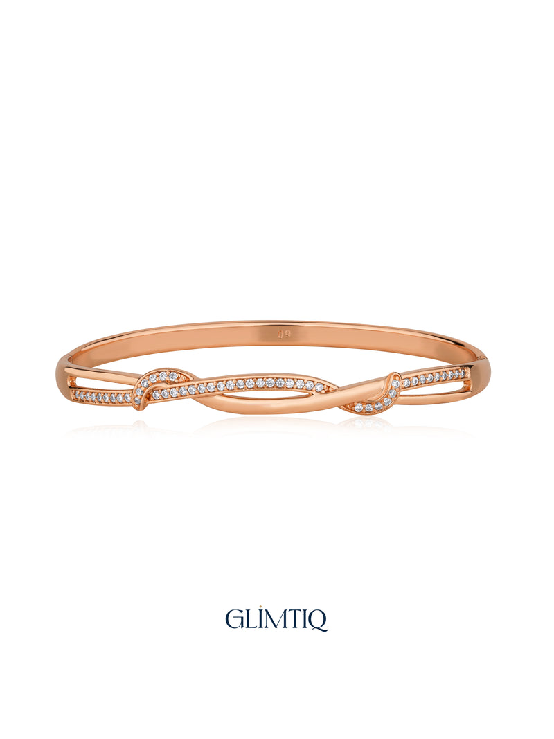 Sparkling Twist rose gold plated bracelet with crossing stone-set curves, studio view
