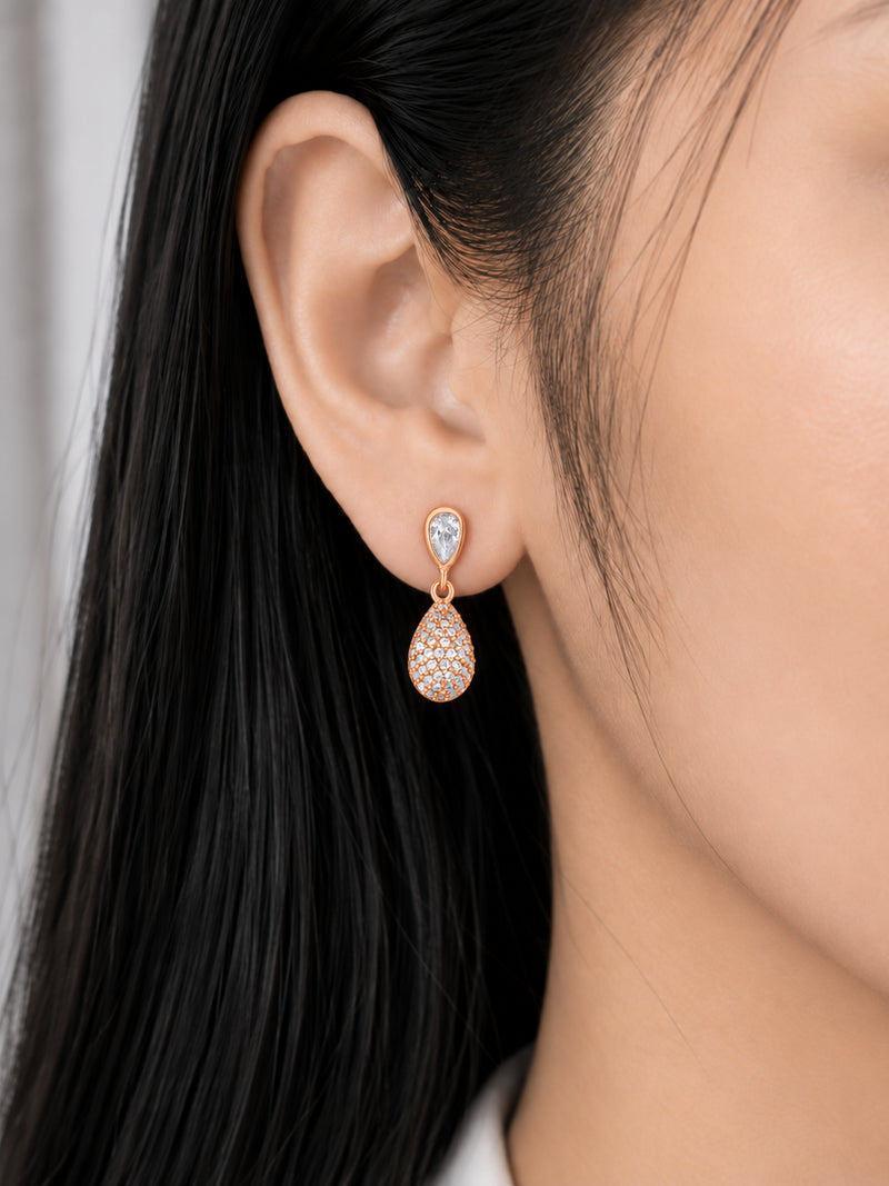 Teardrop Cascade 18K Rose Gold Plated Drop Earrings worn on a model's ear