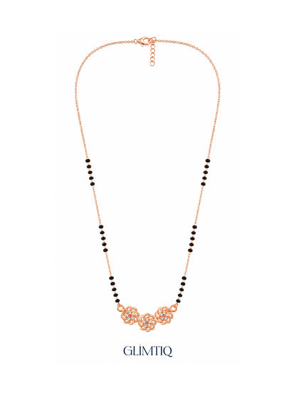 Full rose gold mangalsutra showing black bead sections, three sculpted rose swirls with sparkling floral centres, lobster clasp and extension chain.