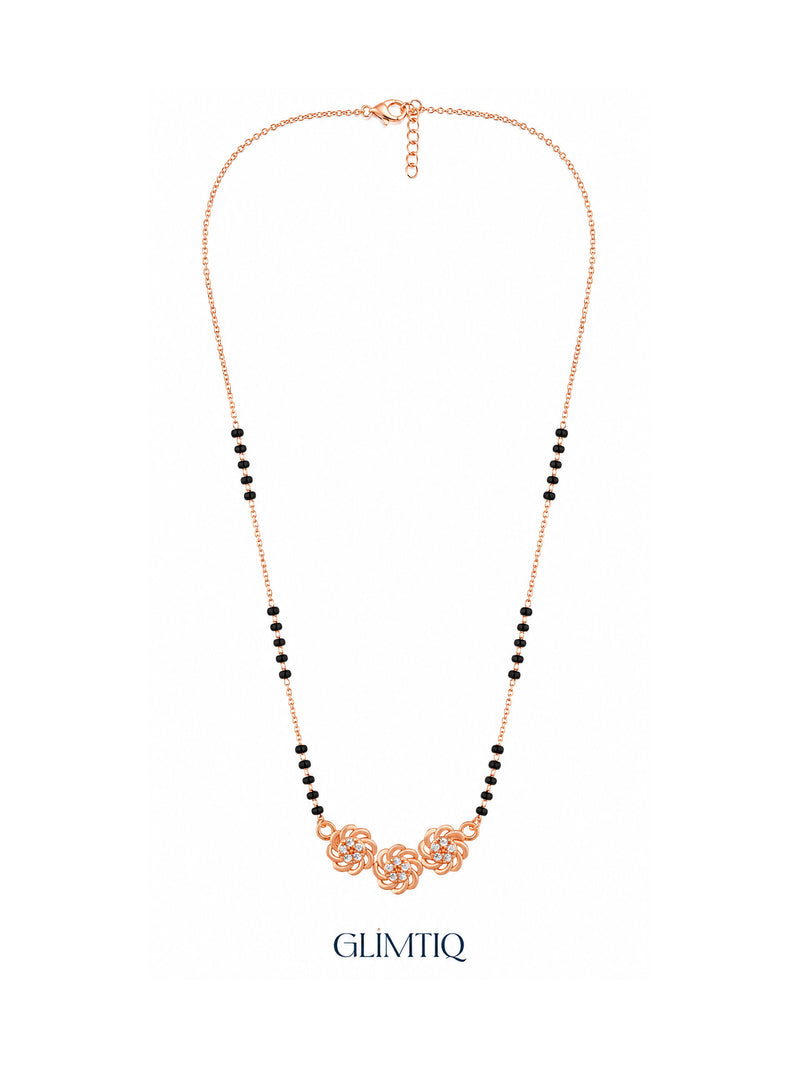 Full rose gold mangalsutra showing black bead sections, three sculpted rose swirls with sparkling floral centres, lobster clasp and extension chain.