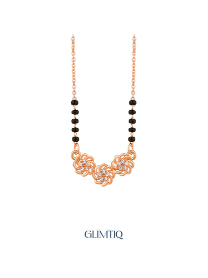 Close-up of rose gold mangalsutra pendant featuring three sculpted rose swirls with sparkling floral centres.