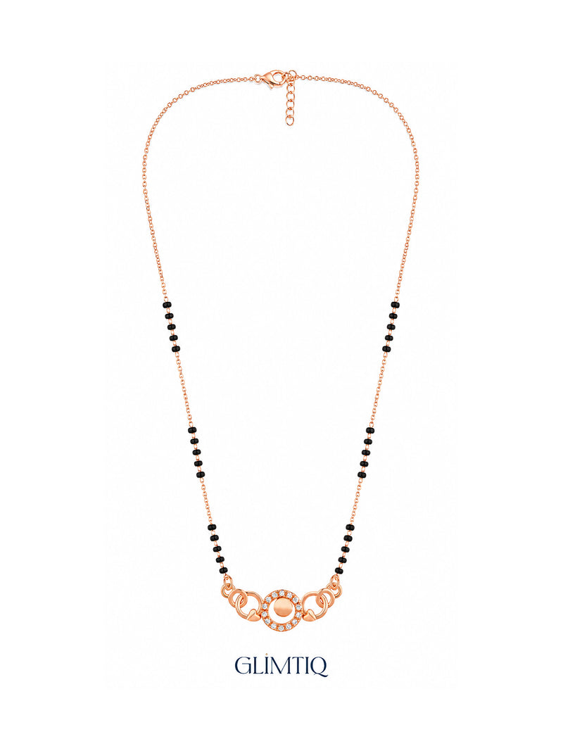 Full rose gold mangalsutra showing black bead sections, sparkling centre circle with twin open circles and heart details, lobster clasp and extension chain.