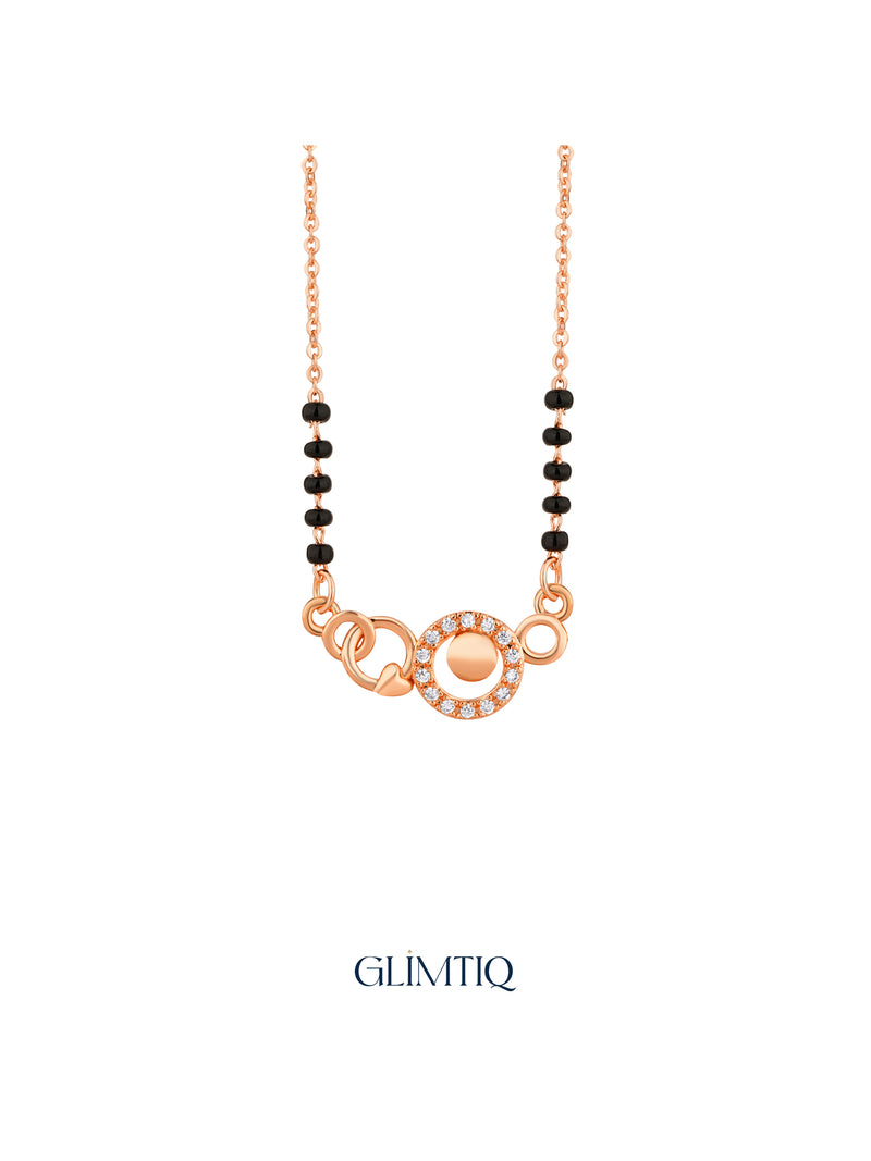 Close-up of rose gold mangalsutra pendant featuring sparkling centre circle with twin open circles and heart details.