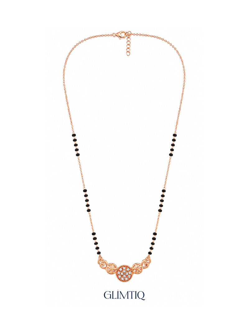 Full rose gold mangalsutra showing black bead sections, twin rose-gold stars framing a sparkling round centre, lobster clasp and extension chain.